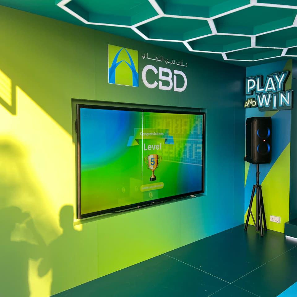 Interactive multi-level touch screen game rental at Dubai 30x30 event, showing guests engaged in a gamified fitness and financial literacy challenge.